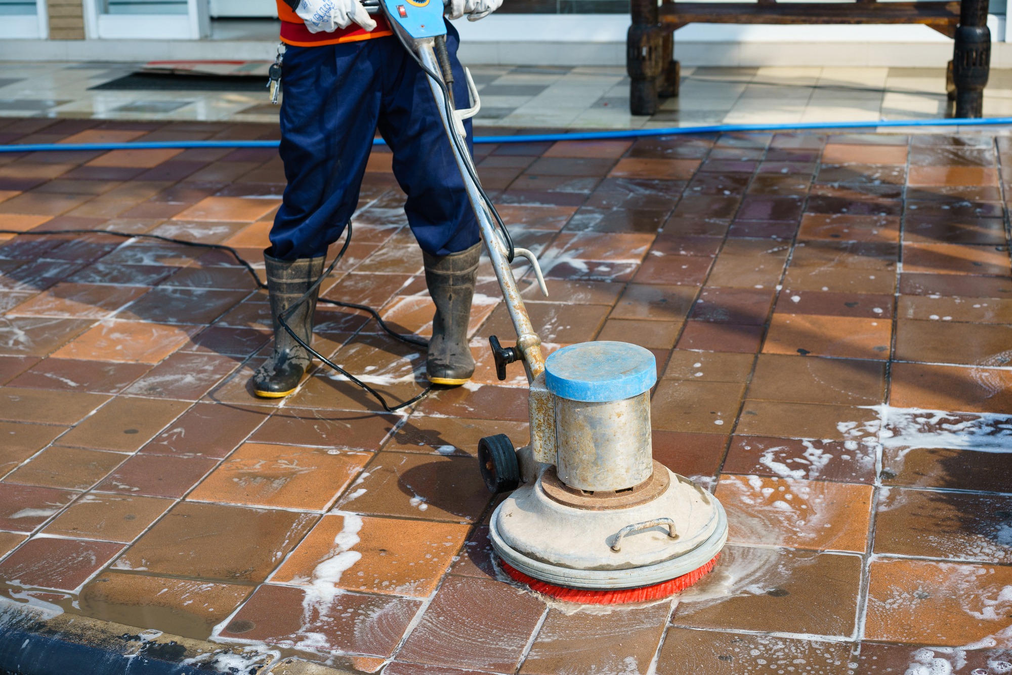 A person cleaning floor with machine